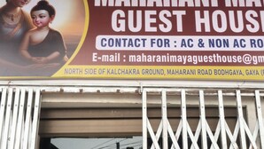 A sign for Maharani May Guest House with contact information and location details. - Maharani Maya Guest House Bodhgaya  (Gaya)