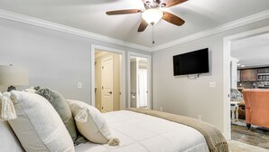A bedroom with a bed, a ceiling fan, a television, and a view into the kitchen. - Chattanooga House w/ Grill: 12 Mi to Downtown! (Chattanooga)