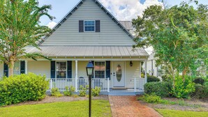 A single-story house with a front porch, a small garden, and a brick pathway leading to the entrance. - Walk to Bay & Dtwn: Port St Joe Paradise w/ Grill! (Port St. Joe)