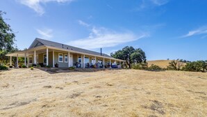 A house with a covered porch, a garage, and a large yard. - Paso Robles Gem w/ On-site Vineyard: Pets Welcome! (Paso Robles)