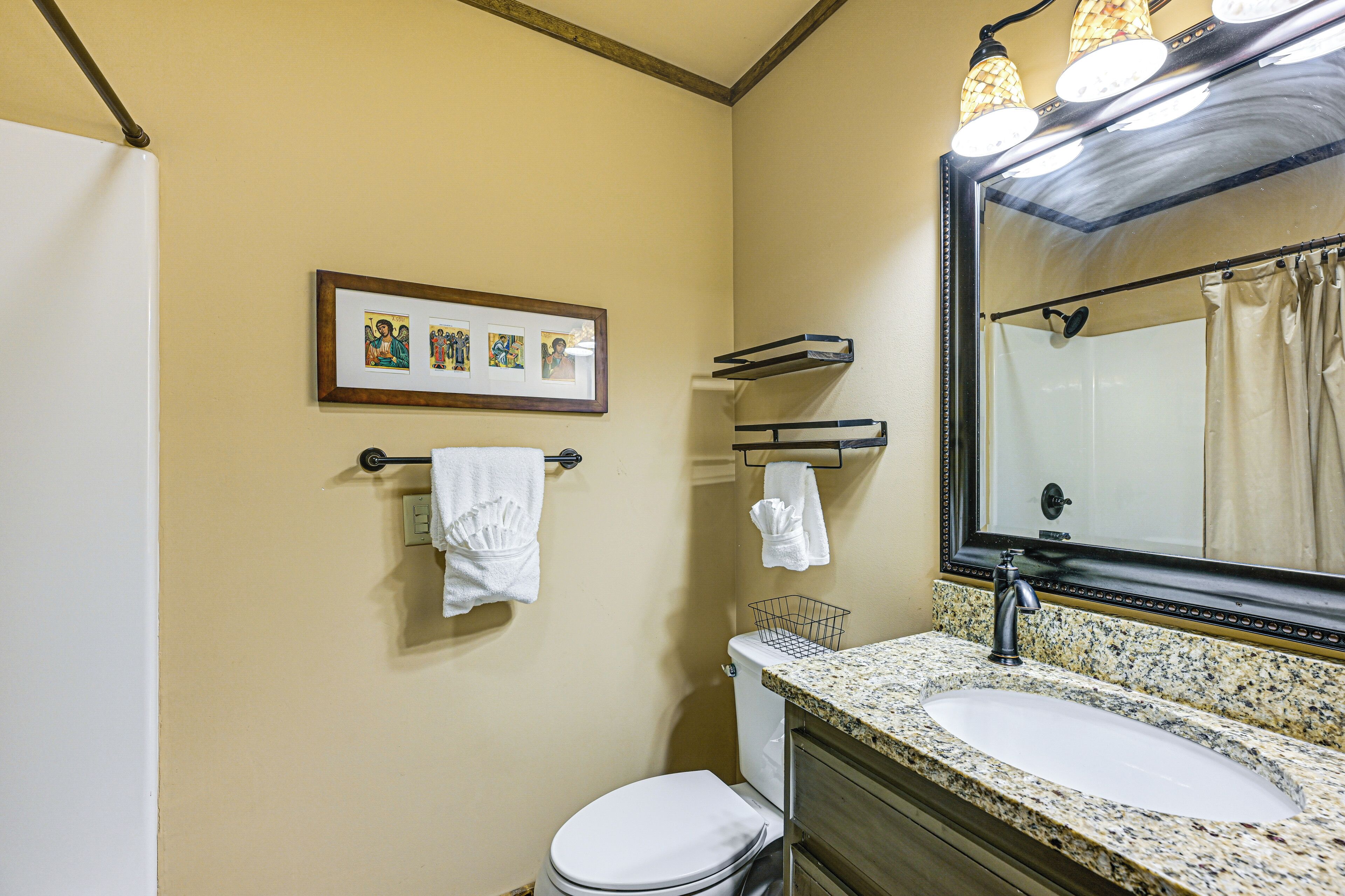 A bathroom with a sink, mirror, and towel rack.