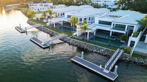 A modern waterfront property with multiple buildings, a dock, and a swimming pool. - Trilogy Villas Denarau (Nadi)
