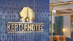 A KEPTURHOTEL sign with a unique design and a glimpse of the interior including a dining area. - Keptur Hotel (Dosemealti)