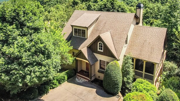 A two-story house with a sloped roof, a chimney, and a front porch. - Paradise View - Big Canoe GA (Big Canoe)