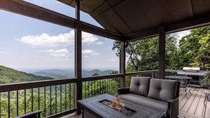 A covered outdoor area with a fire feature, seating, and a grill. - Southern Views - Big Canoe GA (Big Canoe)