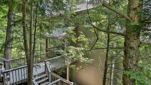 A wooden staircase leading to a house surrounded by dense trees. - Southern Views - Big Canoe GA (Big Canoe)