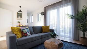 Deluxe Apartment, 1 Bedroom, Balcony | Living area | Flat-screen TV