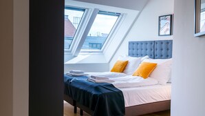 A bedroom with a bed, a headboard, a window, and a framed picture on the wall. - Vienna Residence, Prater - Exhibition Center #6485 (Vienna)