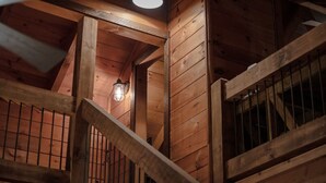 A wooden staircase with a lantern and a ceiling light. - Olivers Hideaway | on Fightingtown Creek (Cherry Log)