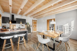 Enjoy meals in the spacious kitchen and dining area with a central island, oven, and large window.