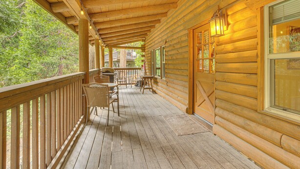 A wooden deck with a railing, wicker chairs, and a table. - Cabin ~ 1 Mi to Lake Gregory & Hiking! (Crestline)
