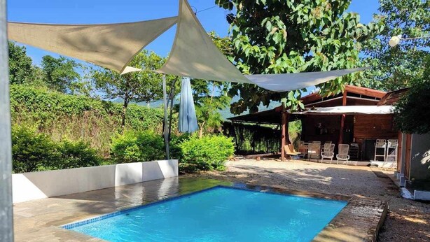 Une piscine rectangulaire à l’eau d’un bleu limpide, entourée d’une terrasse carrelée.
