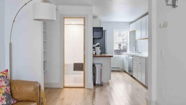 A modern apartment with a kitchen, a dining area, and a living room. - Petite+Perfect Modern Pad: parking+laundry+yard (Burlington)