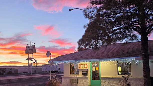 A motel with a 'Sands Motel' sign, an 'Office' sign, and a green awning. - Southwest Motel (Grants)
