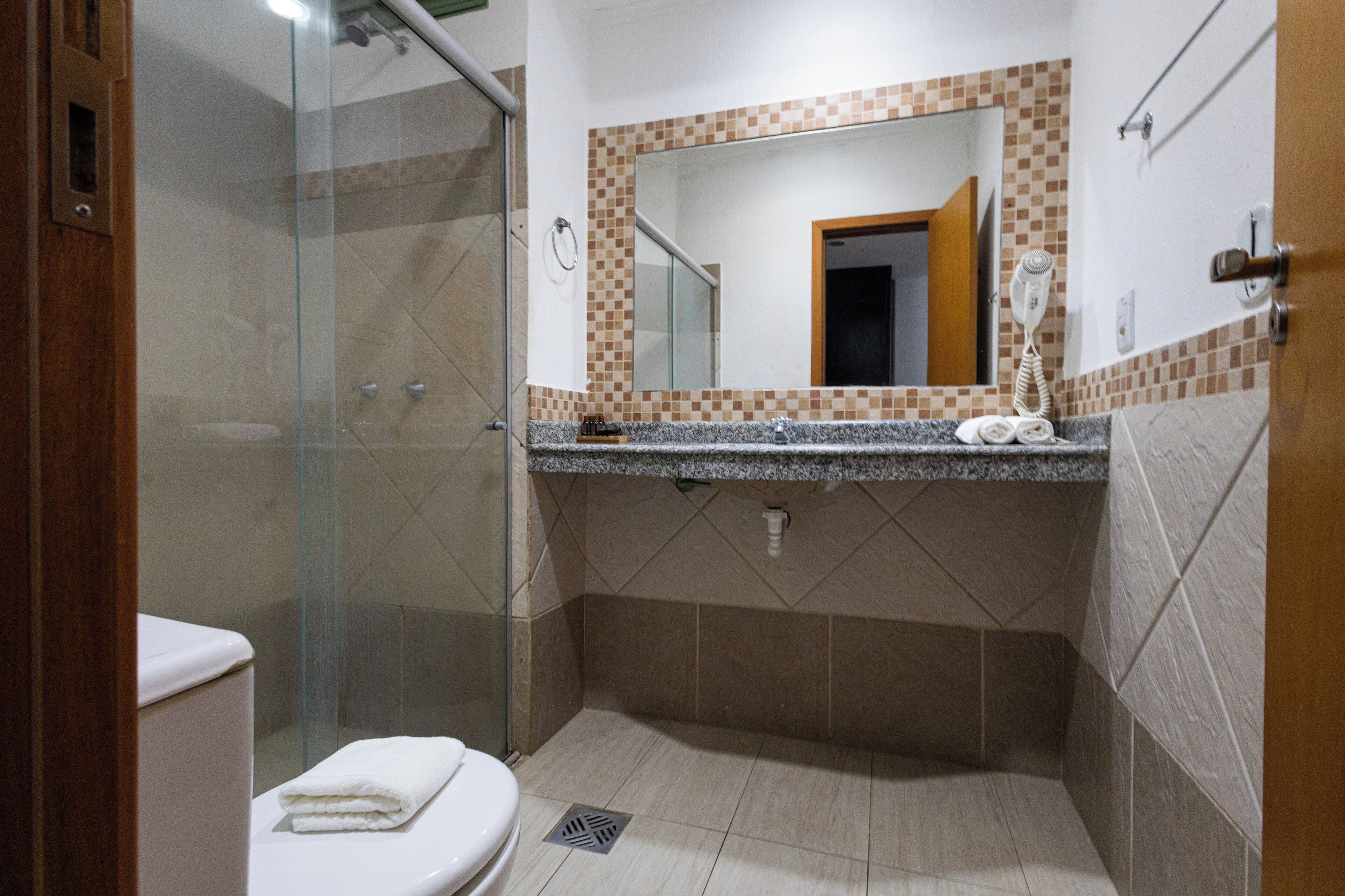 Chuveiro, toalhas de banho, sabonete, shampoo