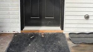 A black front door with a white-framed window, a mailbox labeled 'C', and a house number 'V'. - Mini Mod Apartment, Private- Parking (Winooski)