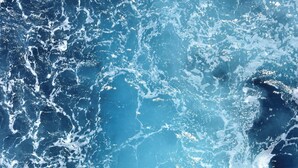 A close-up of ocean waves with white foam.
