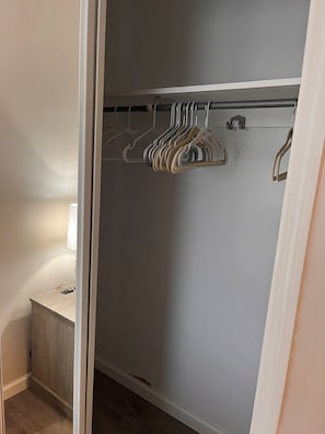 Store your belongings in this spacious closet with a rod for hanging clothes and a bench for placing shoes.