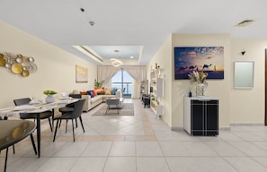 Relax in this stylish living area with a sofa, coffee table, and dining space for four.