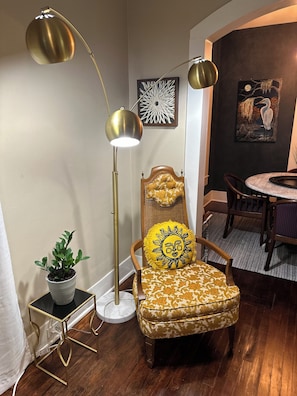 Relax in a stylish space with a vintage floor lamp, a comfortable chair, and a side table.