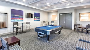 A pool table in a room with chairs, a television, and artwork on the walls. - 1Bed/1Bath Desert Blue Margaritaville! (Las Vegas)
