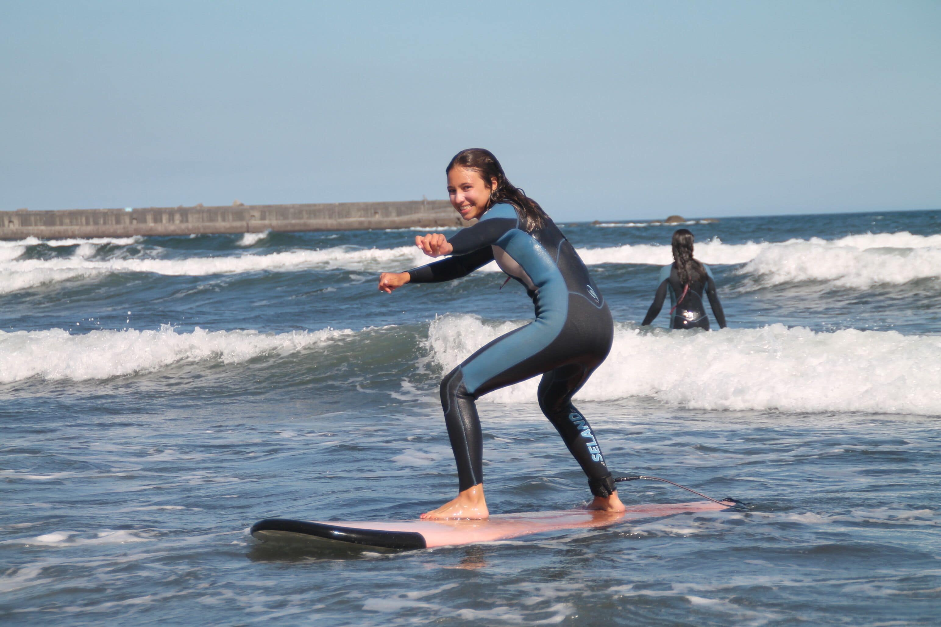 A person surfing on a board in the ocean.