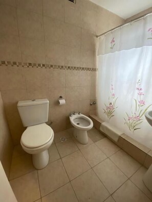 A bathroom with a toilet, bidet, and bathtub. - Hotel Bariloche Garden (San Carlos de Bariloche)