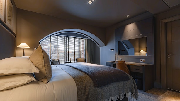 A modern hotel room with a large bed, a desk, and a television. - Dakota Newcastle (Newcastle-upon-Tyne)