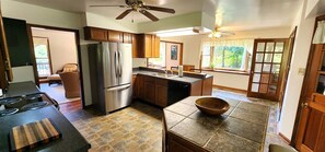 Enjoy cooking in this well-equipped kitchen with a refrigerator, oven, and dining area.