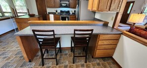 Enjoy cooking in this well-equipped kitchen with a central island and ample seating for two.