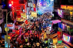 A crowded street scene with numerous people and brightly lit signs. - The Rice Hotel & Tour - 131 Bui Vien (Ho Chi Minh City)