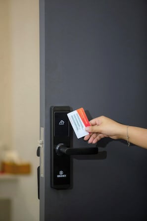 A hand inserting a card into a card reader on a door. - The Rice Hotel & Tour - 131 Bui Vien (Ho Chi Minh City)
