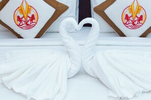 A bed with white linens and a heart-shaped towel arrangement. - The Rice Hotel & Tour - 131 Bui Vien (Ho Chi Minh City)
