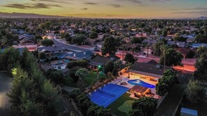 A residential area with houses, a swimming pool, and a tennis court. - Backyard Paradise in Chandler (Chandler)