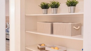 A neatly organized storage unit with shelves, baskets, and a small wooden box. - Backyard Paradise in Chandler (Chandler)