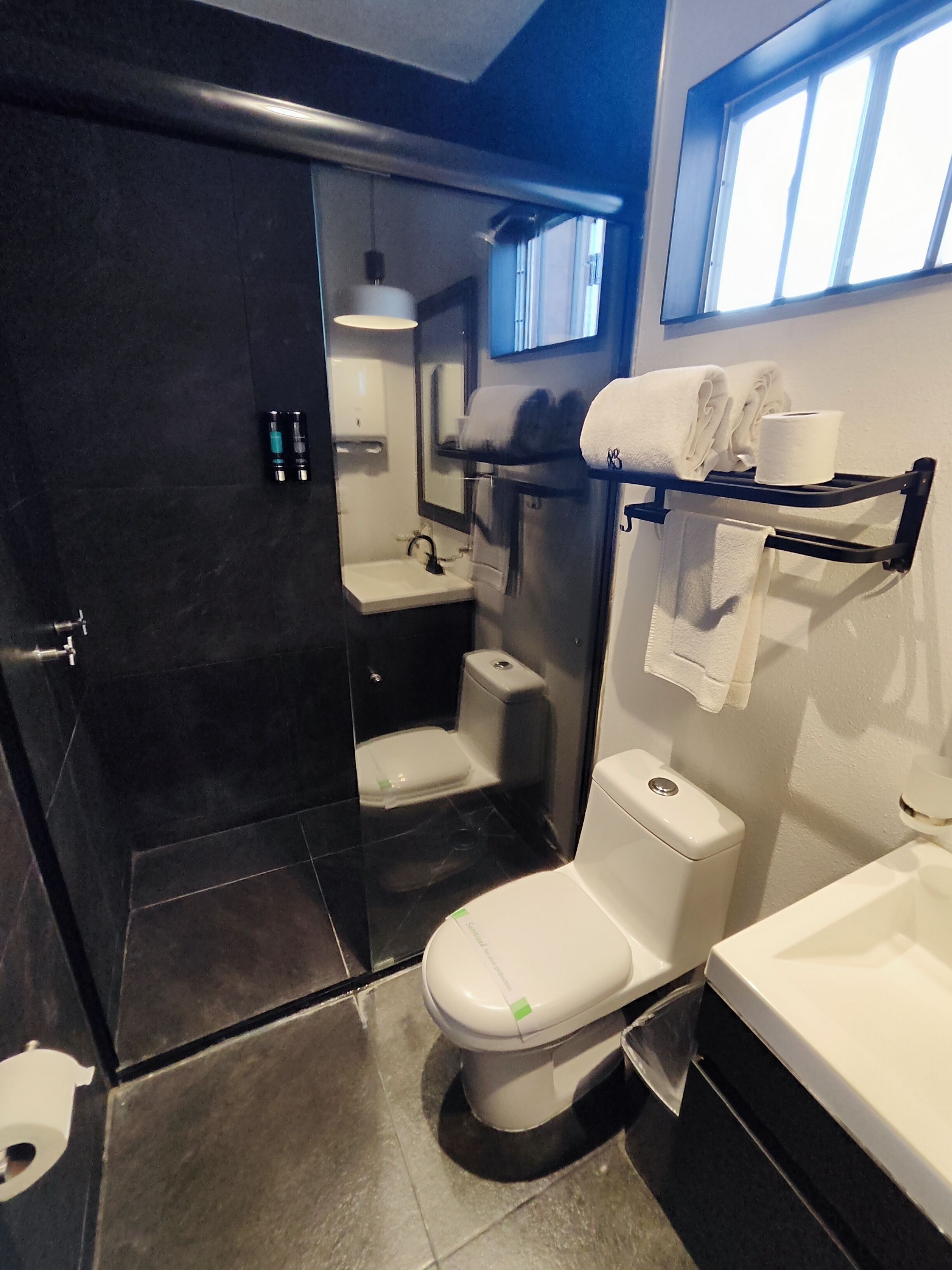 A modern bathroom with a toilet, sink, and bathtub.