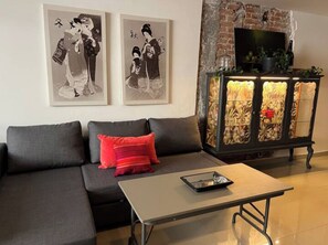 Relax in this stylish living room with a sofa, coffee table, and decorative cabinet.