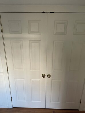 A closed white door with a handle and a keyhole.