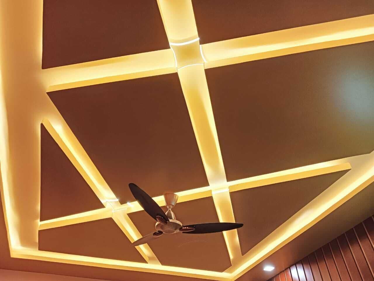 A ceiling with a geometric light fixture and a ceiling fan.