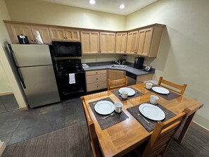 Enjoy cooking and dining in this well-equipped kitchen with modern appliances and a dining area for four.