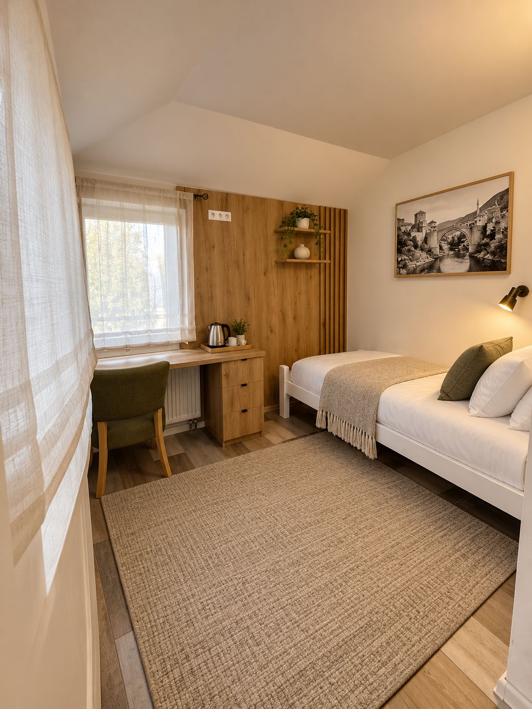 A bedroom with a bed, a desk, a chair, a radiator, a window with curtains, a wall-mounted shelf with plants, and a framed picture on the wall.