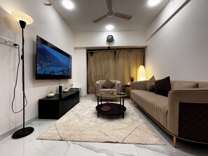 Smart TV, books - Sky Oasis: Premium 2BHK I 65' TV, AC, High Floor, Andheri West (Jogeshwari West Mumbai)