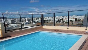 A rooftop pool with a clear view of the cityscape.