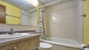 Un baño con lavamanos, inodoro y bañera.