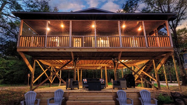A wooden deck with outdoor seating and a covered area.