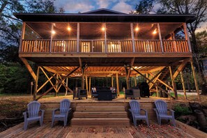 A wooden deck with outdoor seating and a covered area.