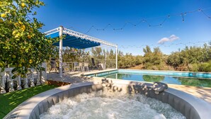 A backyard with a hot tub, a pool, and a covered patio area. - Amazing home in Setenil de las Bodegas (Setenil de las Bodegas)
