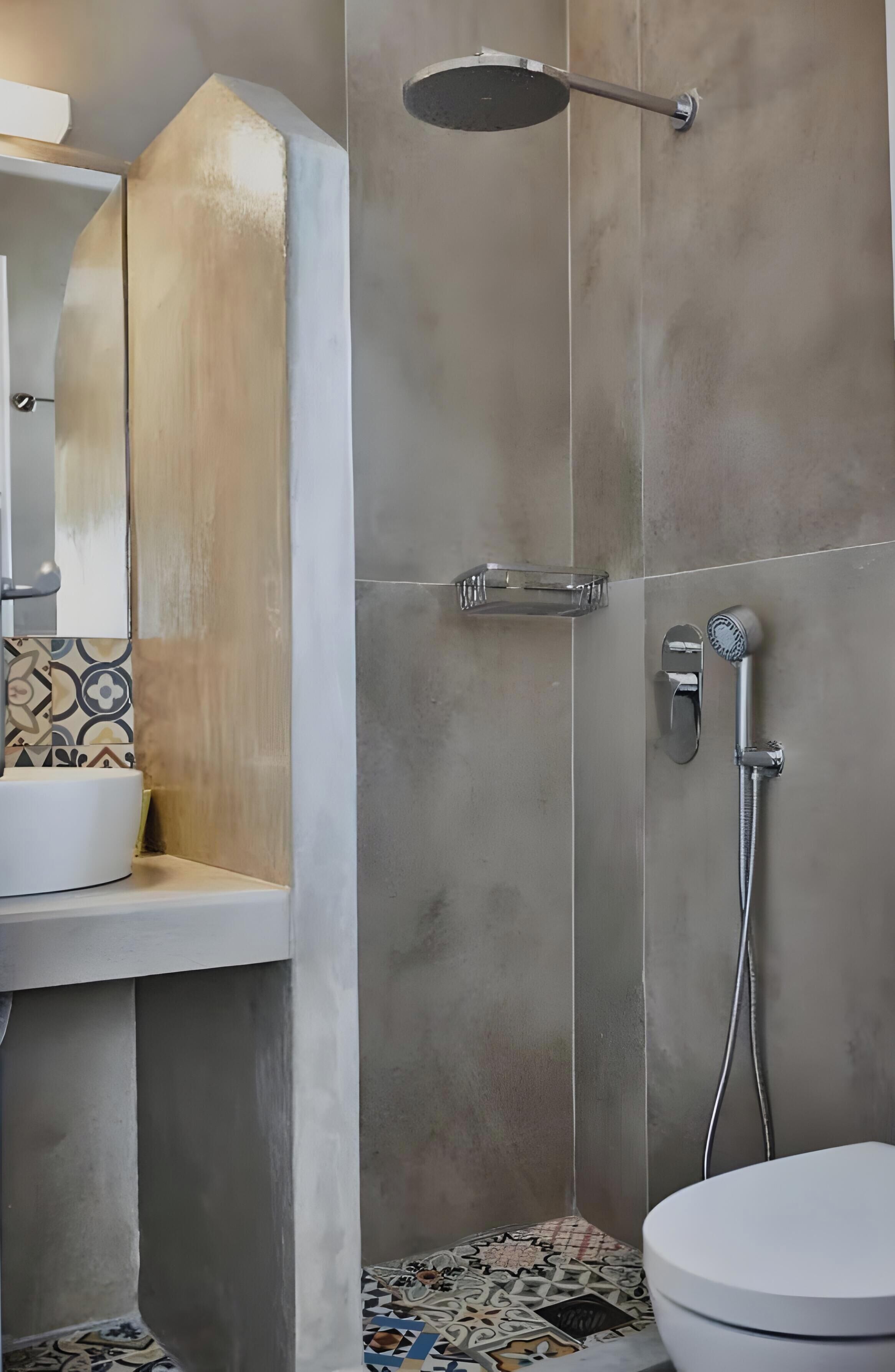 A modern bathroom with a shower, toilet, and sink.