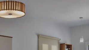 A compact kitchen with a refrigerator, wooden cabinets, a small sink, and a dining area with two chairs. - Apartment 'Irene 13 Superior  1' with Sea View, Wi-Fi and Air Conditioning (Andros)