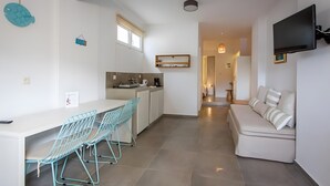 A compact living space with a kitchenette, dining area, and seating area. - Studio Apartment 'Semi Basement -Superior Apartment' with Mountain View and Air Conditioning (Andros)